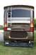 2003 Ford F-350 - The rear of a large RV shows a ladder, taillights, and a license plate.