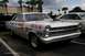 1967 Ford Fairlane - White 1966 Ford Fairlane drag car with extensive racing decals and a prominent hood scoop is parked next to another vehicle.
