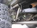 1974 Ford Bronco - Rear suspension detail showing a tire, coil spring, and Bilstein shock absorber mounted to the frame.