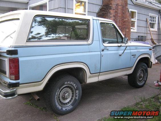 Light blue and white Ford Bronco parked in a driveway