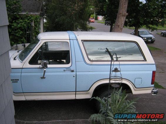 Light blue and white Ford Bronco parked on a driveway