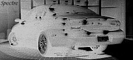 Rear view of a car with significant damage to the body panels and lights