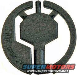 Black plastic part with circular and hexagonal elements, text 'FOR ALL' visible