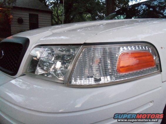 White 2000 Mercury Grand Marquis front corner with clear headlight and orange turn signal