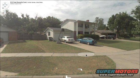 Silver 2000 Mercury Grand Marquis parked in driveway, side view