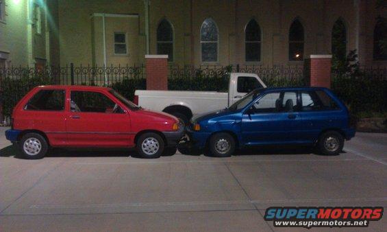 1991 Ford Festiva and a blue car parked next to each other
