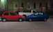 1991 Ford Festiva - Two subcompact hatchbacks, a red 1991 Ford Festiva and a blue car, are parked side-by-side.