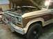 1983 Ford Bronco - The front of a classic Ford Bronco is shown with its hood open, revealing the engine compartment.