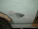 1983 Ford Bronco - Bodywork repair in progress on a vehicle, with primer and filler applied to the rear fender area.