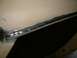 1983 Ford Bronco - A close-up view of chrome trim on a vehicle's body panel, with visible signs of wear and repair.
