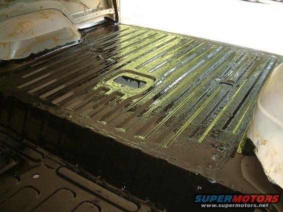 Interior cargo area of a 1983 Ford Bronco with black protective coating applied