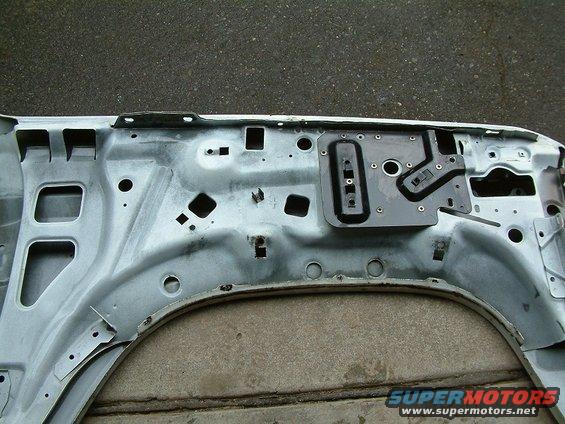 Interior structure of a car door, showing metal bracing and mounting points