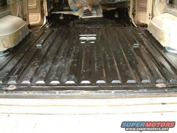 Interior floor of a vehicle with black protective coating applied