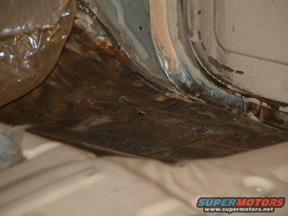 Rusted floor pan and rocker panel interior view