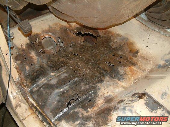 rusted out floor pan with holes, near brake pedal