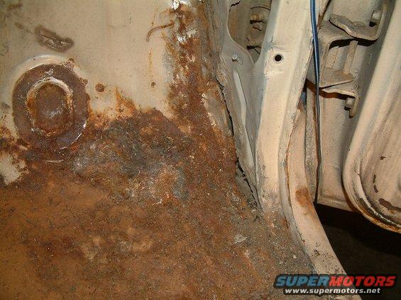 Rusted metal panel with visible bolts and wiring