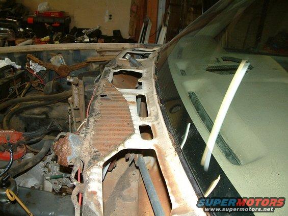 1983 Ford Bronco engine bay with rusted cowl and windshield frame