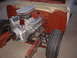 1964 Ford Fairlane - A V8 engine is installed in the engine bay, with an air filter visible above the carburetor. The front tire and suspension components are a…
