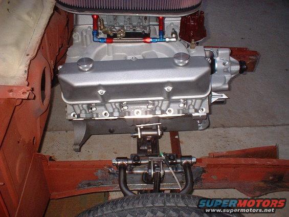 Engine and front suspension assembly with silver valve covers and red distributor cap