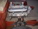 1964 Ford Fairlane - Close-up view of a V8 engine and its front suspension components, aftermarket valve covers and fuel lines.