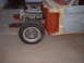 1964 Ford Fairlane - The front section of a car is shown with the engine and wheel, in a state of repair.