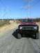 1978 International Scout II - A 1978 International Scout II is parked on a gravel road under a clear blue sky with power line towers in the background.