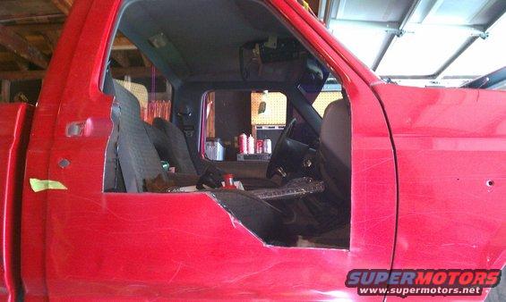 Red truck cab interior with cut-out door panel. 1994 Ford F-250