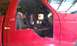 1994 Ford F-250 - Interior view of a red 1994 Ford F-250 truck cab, showing the driver's side with a modified door panel.