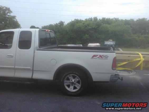 White pickup truck bed loaded with lumber, FX4 Off Road decal visible