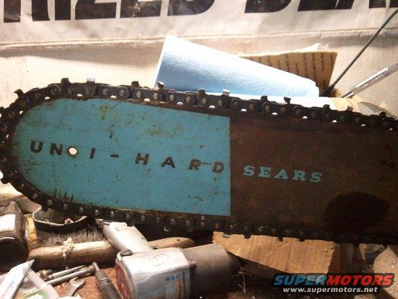 Chainsaw bar with blue and brown paint, reading "UNOI-HARD SEARS"