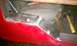 1994 Ford F-250 - Metal repair work is visible on the interior of a red vehicle door, with tools nearby.