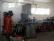 1996 Ford Bronco - Workshop interior with various tools and machinery, including a band saw and air compressor.