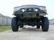 1996 Ford Bronco - Front view of a heavily modified 1992 Ford Bronco with off-road tires and a custom bumper.