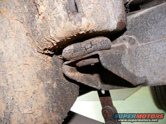 Cracked rubber body mount on vehicle chassis