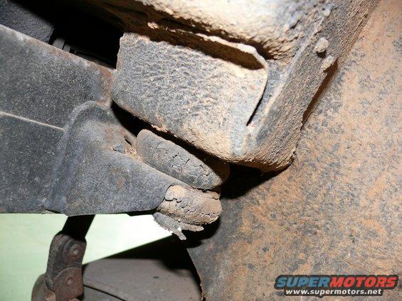 Close-up of rusted metal frame and suspension parts, showing wear and corrosion