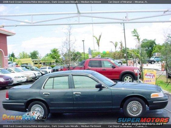 Dark green 1998 Ford Crown Victoria Police Interceptor, side view, parked outdoors