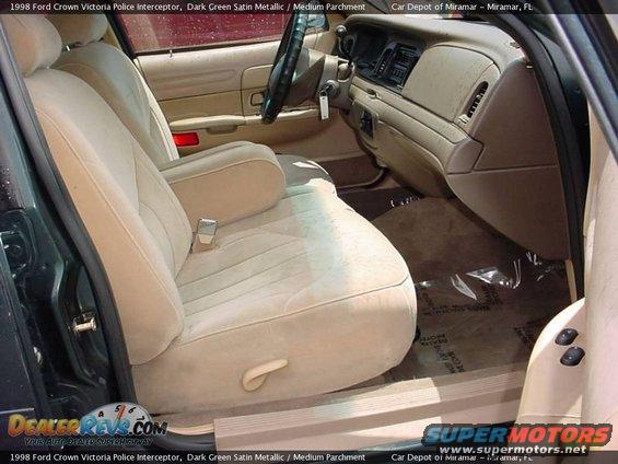 Interior of a 1998 Ford Crown Victoria Police Interceptor, showing tan cloth seats and dashboard
