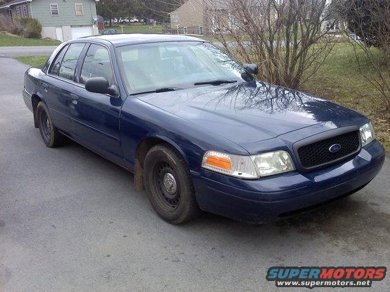 Blue 2002 Ford Crown Victoria parked on asphalt driveway