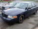 2002 Ford Crown Victoria - Two Ford Crown Victoria sedans are parked side-by-side outdoors.