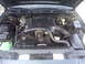 1998 Ford Crown Victoria - The engine bay of a 1998 Ford Crown Victoria is captured, revealing the V8 engine and associated parts.
