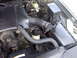 1998 Ford Crown Victoria - Close-up view of a car's engine bay, showing various components and hoses.