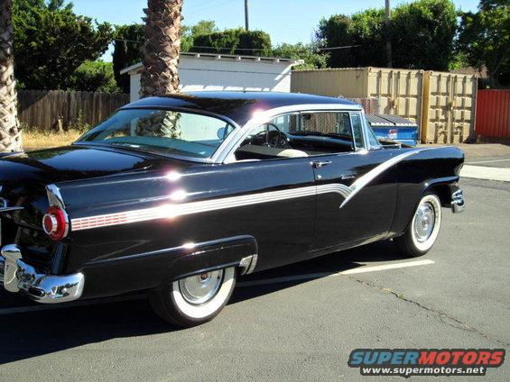 Black 1956 Ford Fairlane, 3/4 front view, white-wall tires, chrome trim
