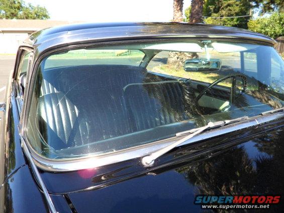 1956 Ford Fairlane interior with black pleated seats and chrome trim