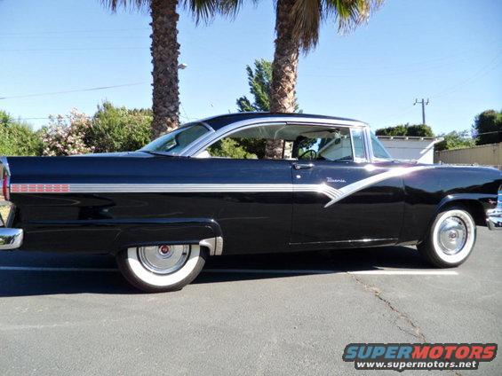 Black 1955 Ford Fairlane Crown Victoria with white roof and trim, seen from the side