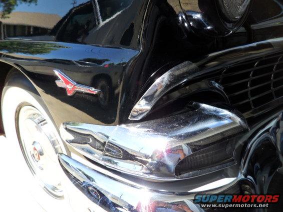 Black 1956 Ford Fairlane front fender with chrome trim and grille detail