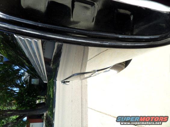 Black 1956 Ford Fairlane side trim with chrome accents, parked outdoors