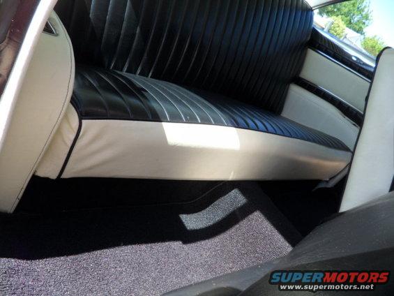 Black and white two-tone interior with pleated seats and carpeted floor
