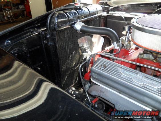 1956 Ford Fairlane engine bay showing radiator, fan, and Thunderbird valve covers
