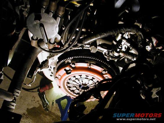 Close-up of an engine clutch assembly with visible flywheel and pressure plate