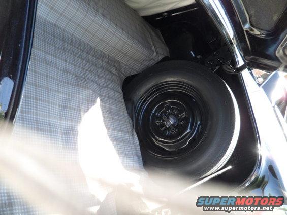 Trunk interior with spare tire and plaid lining